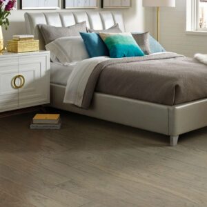 Gray hardwood bedroom flooring | Howmar Carpet Inc