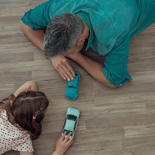 Father and daughter playing with car toys | Howmar Carpet Inc