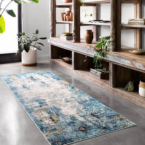 Contrast colored area rug protecting laminate flooring | Howmar Carpet Inc