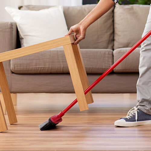 Man cleaning vinyl flooring | Howmar Carpet Inc