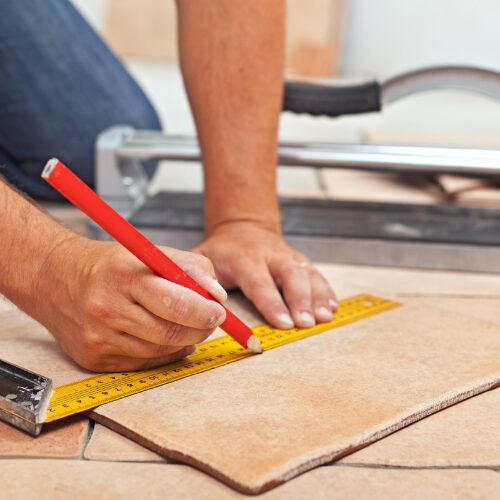 Man installing tiles | Howmar Carpet Inc